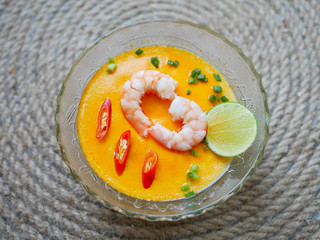 top view Spicy steamed egg with shrimps in glass bowl