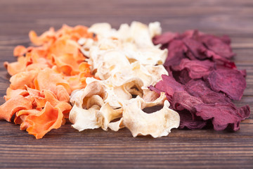 Set of chips from vegetables and fruits in craft bowls. Dried vegetables and fruits. An organic snack for the whole family. Healthy eating concept. Close up photo, selected focus