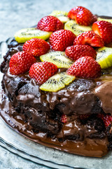 Close up Macro View of Homemade Whole Layer Chocolate Cake with Strawberries and Kiwi for Birthday.