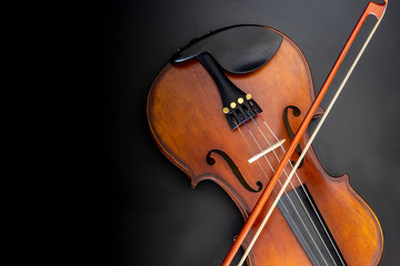 violin with violin bow black background top view 