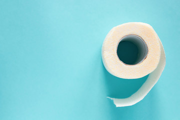 Toilet paper on a blue background top view