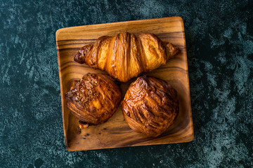 Assortment of Assorted Croissant Varieties om Wooden Plate / Variety of Bakery Pastries.