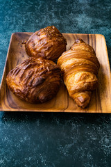Assortment of Assorted Croissant Varieties om Wooden Plate / Variety of Bakery Pastries.