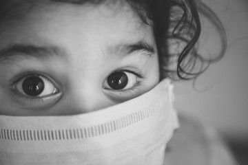 Corona virus COVID-19 epidemic outbreak quarantine concept of cute sick little girl wearing protection medical mask