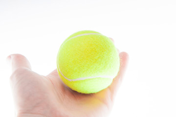 The tennis ball on the man's hand