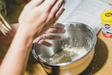 Dusting off hands while making dough