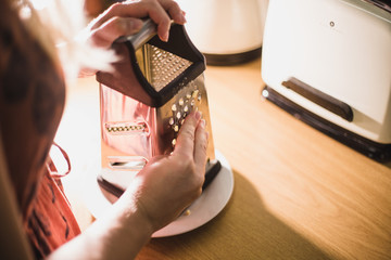 Grating cheese with grater