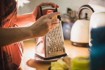 Grating cheese with grater