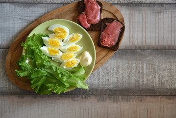 boiled egg breakfast with a sandwich with red fish