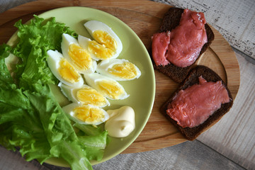 boiled egg breakfast with a sandwich with red fish