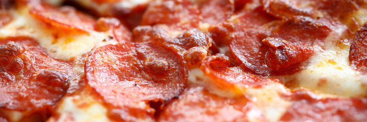 Fresh baked pizza with crusty cheese and hot tasty pepperoni ready to eat