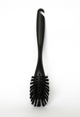 Aerial view of black dishwasher brush with bristles, handle and hole for hanging when not in use. Close up of Cleaning utensil made with recyclable materials isolated on white background.