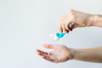 hands closeup. a person uses a sanitizer. hand disinfection. safety. social distance.