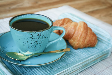 Cup of coffee with croissant