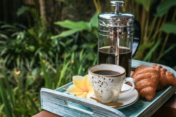 Cup of coffee with croissant