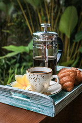 Cup of coffee with croissant