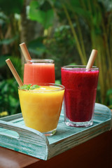 Dragon fruit, papaya and mango smoothies