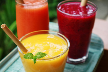 Dragon fruit, papaya and mango smoothies