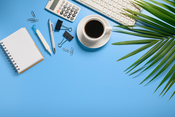 Top view,flat lay,notebook,pen,paperclip,coffee cup or object for office apply concept on blue background.