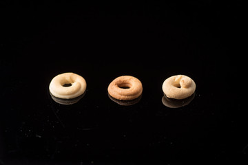 Spanish artisan donut, with flour, sugar, butter, eggs. Photo on methacrylate with reflection.