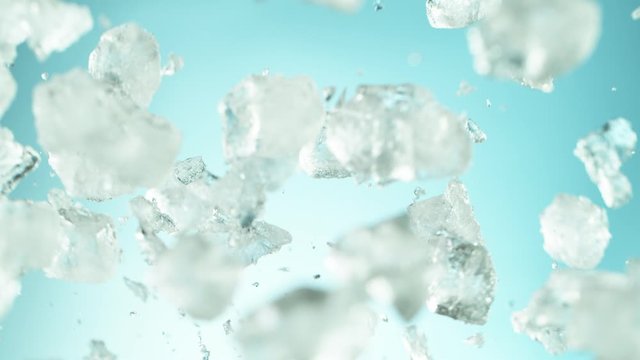 Super slow motion of falling ice cubes separated on blue background. Filmed on high speed cinema camera, 1000 fps.