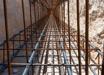 Design of reinforced concrete foundations. Constructed by workers. Metal framework. Business, buildings.