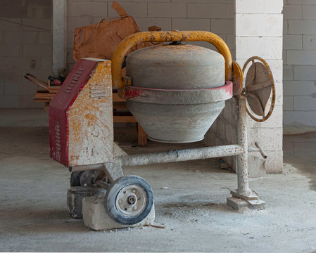 Old dirty cement mixer at a construction site. Background, motor.