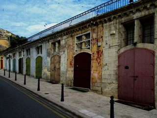 Obraz premium Colorful doors. Warehouses in the old port. Old city of Valletta. Malta Island.
