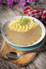 Pure white borscht served with mashed potatoes.