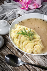 Pure white borscht served with mashed potatoes.