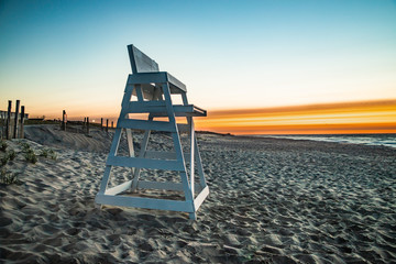 An empty lifeguard stand is the only witness to the beautiful dawn display at the beach