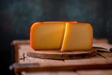 Hard cheese parmesan on wooden board on sunlight table traditional table texture
