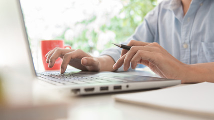 newsletter concept Hand of businessman checking message box on digital laptop Vintage tone...