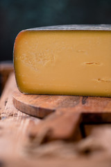 Hard cheese parmesan on wooden board on sunlight table traditional table texture