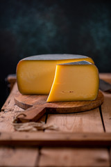 Hard cheese parmesan on wooden board on sunlight table traditional table texture