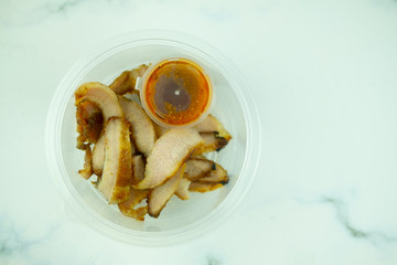 Charcoal-boiled pork neck with the sauce in takeaway box