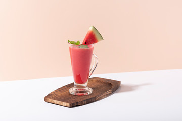 Fresh water melon juice and watermelon slice on color background. summer drink.