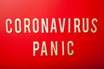 coronavirus panic word text wooden letter on red background coronavirus covid-19