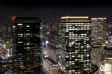 Fototapeta na wymiar Modern high rise buildings at night in Osaka, Japan.