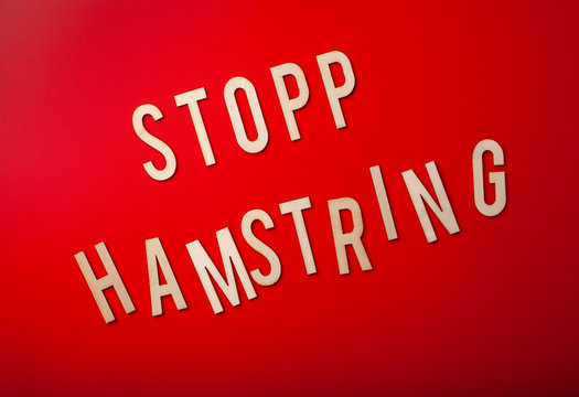 stopp hamstring norwegian word text wooden letter on red background coronavirus covid-19