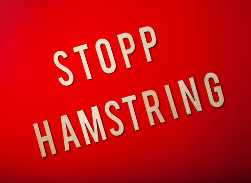 stopp hamstring norwegian word text wooden letter on red background coronavirus covid-19