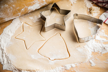 Christmas cookie cutters on dough. 