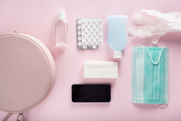 protective medical mask, sanitizer gel and gloves in bag. protective measures against virus, bacteria