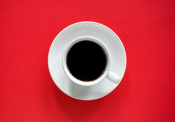 Cup of black coffee on abstract red and brown background with copy space