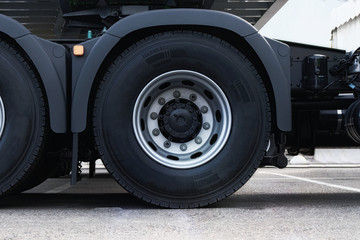 Fototapeta na wymiar Truck tire, wheel of heavy duty semi truck, close up. Freight industry transport, wheels of modern truck.