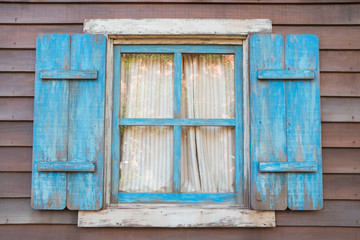 Blue vintage window on a wooden wall.