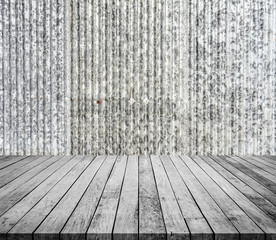 Empty old wooden table or wood floor for product placement or montage with old galvanize sheet background.
