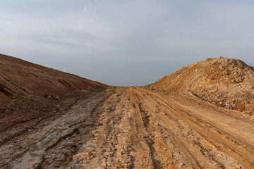 Wide dirt slope road landscape