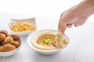 arab breakfast with hummus and falafel and fattah and foul on white wooden table Jordanian food 