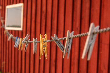 Pegs on a string on a red background